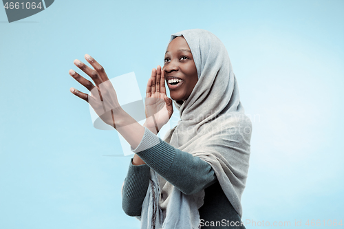 Image of Isolated on blue young africasual woman shouting at studio