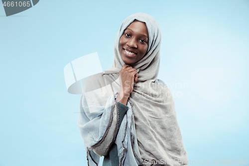 Image of The beautiful young black muslim girl wearing gray hijab, with a happy smile on her face.