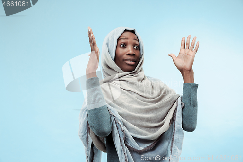 Image of The beautiful young black muslim girl wearing gray hijab, with a happy smile on her face.