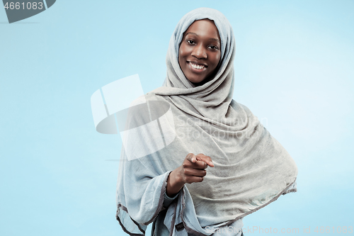 Image of The beautiful young black muslim girl wearing gray hijab, with a happy smile on her face.