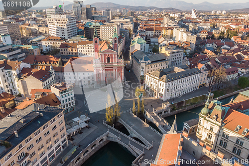 Image of Aerial drone view of Preseren Squere and Triple Bridge over Ljubljanica river,Tromostovje, Ljubljana, Slovenia. Empty streets during corona virus pandemic social distancing measures