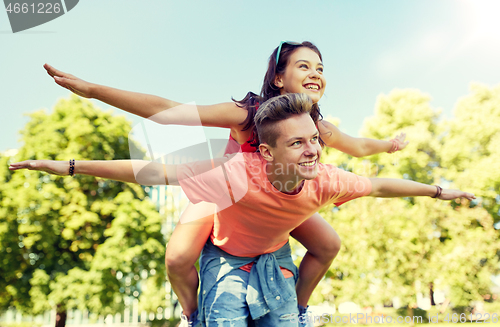 Image of happy teenage couple having fun at summer park