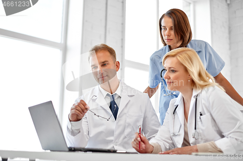 Image of group of doctors with laptop computer at hospital