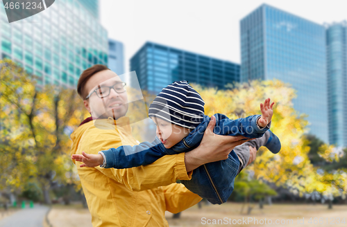 Image of father with son having fun in autumn tokyo city