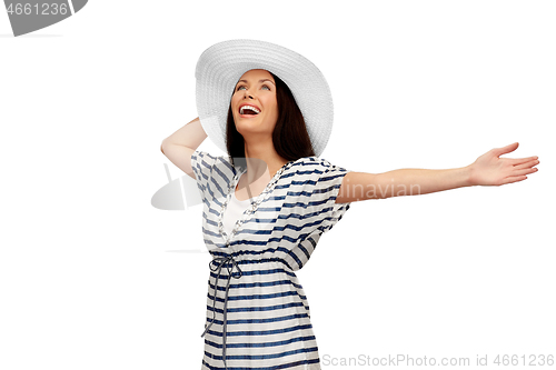 Image of young woman in striped tunic and sun hat