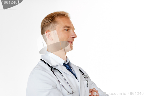 Image of smiling doctor in white coat at medical office