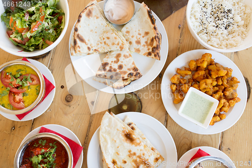 Image of various food on table of indian restaurant