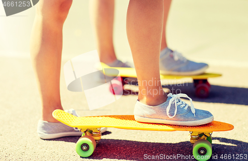 Image of close up of female feet riding short skateboard