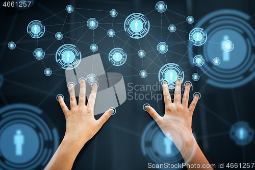 Image of hands using interactive panel with network icons