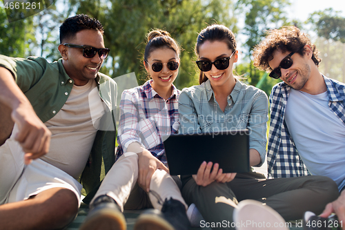 Image of friends with tablet pc computer outdoors in summer