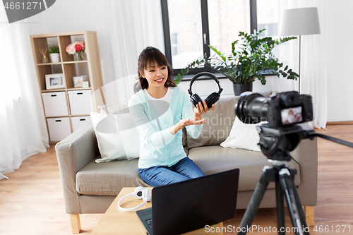 Image of female blogger with headphones making video blog