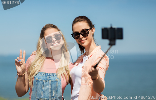 Image of teenage girls or friends taking selfie in summer