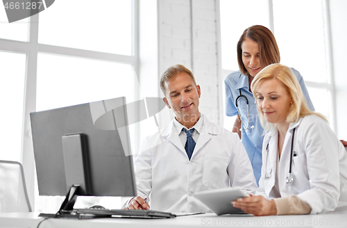 Image of group of doctors with tablet computer at hospital