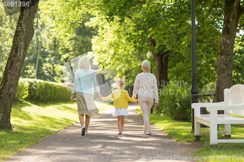 Image of mother, daughter and grandmother walking at park