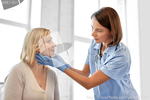 Image of doctor checking patient\'s tonsils at hospital