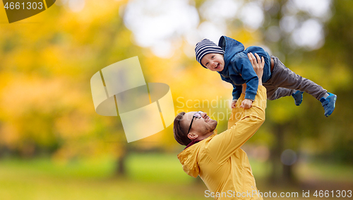 Image of father with son playing and having fun in autumn