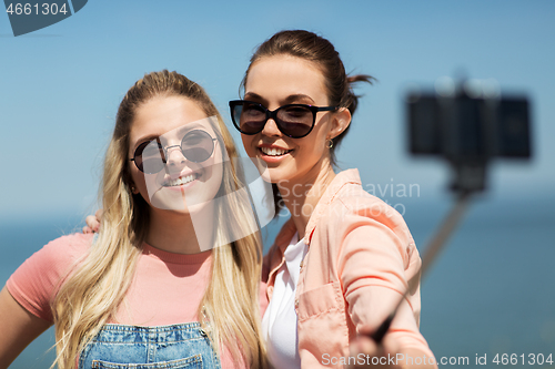 Image of teenage girls or friends taking selfie in summer