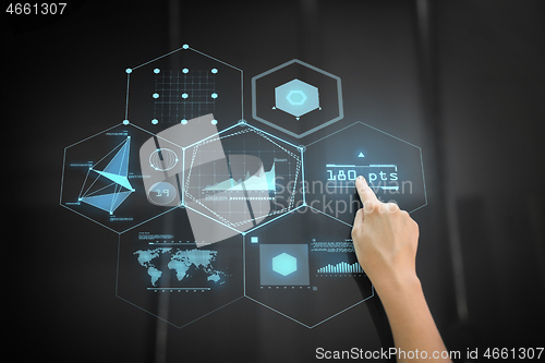 Image of hand using black interactive panel with charts