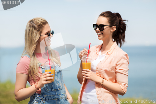 Image of teenage girls or friends with drinks in summer
