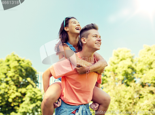 Image of happy teenage couple having fun at summer park