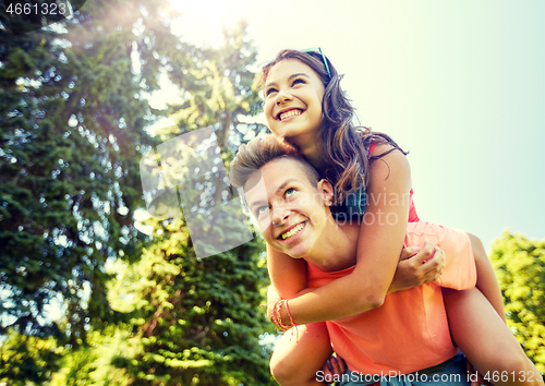 Image of happy teenage couple having fun at summer park