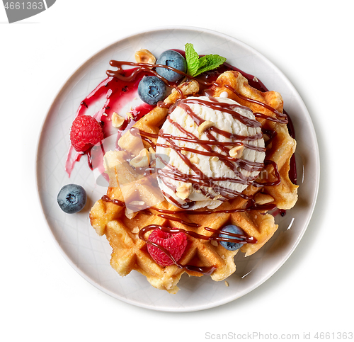 Image of belgian waffle with ice cream and fresh berries