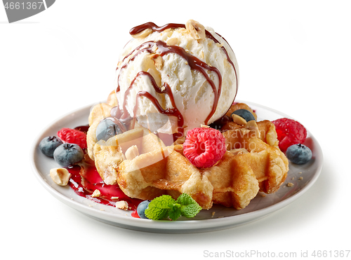 Image of belgian waffle with ice cream and fresh berries