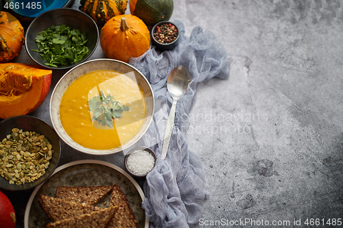 Image of Pumpkin soup decorated with parsley for Thanksgiving, halloween.