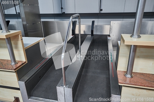 Image of Check-in counter and baggage conveyor at an airport