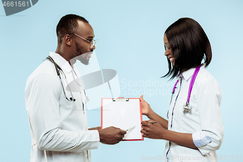 Image of The female and male f happy afro american doctors on blue background