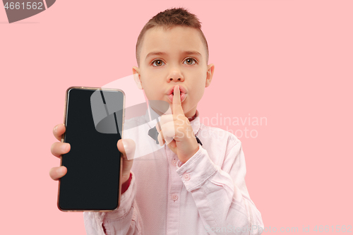 Image of Indoor portrait of attractive young boy holding blank smartphone