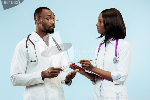 Image of The female and male f happy afro american doctors on blue background