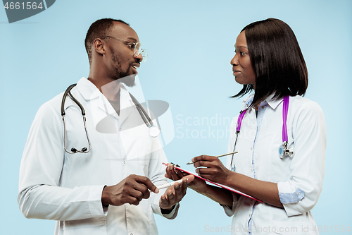 Image of The female and male f happy afro american doctors on blue background