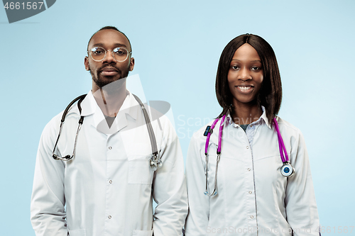 Image of The female and male f happy afro american doctors on blue background