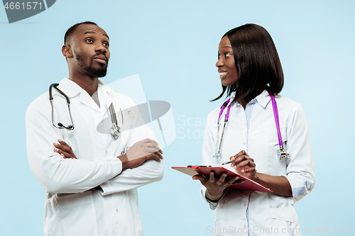 Image of The female and male f happy afro american doctors on blue background