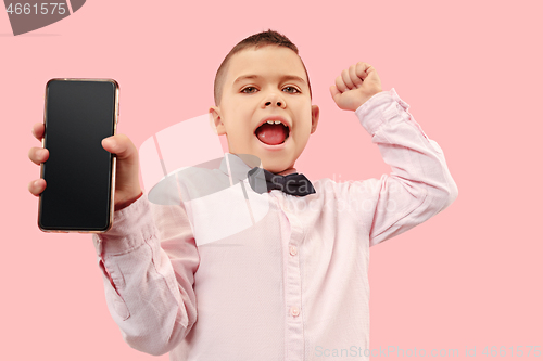 Image of Indoor portrait of attractive young boy holding blank smartphone