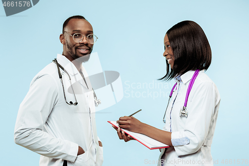 Image of The female and male f happy afro american doctors on blue background