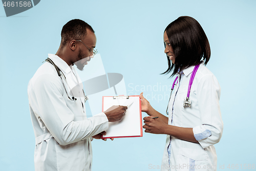 Image of The female and male f happy afro american doctors on blue background