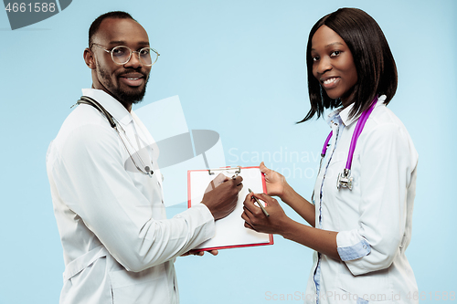 Image of The female and male f happy afro american doctors on blue background