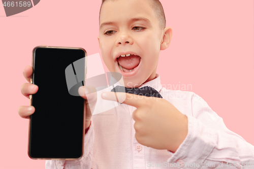 Image of Indoor portrait of attractive young boy holding blank smartphone