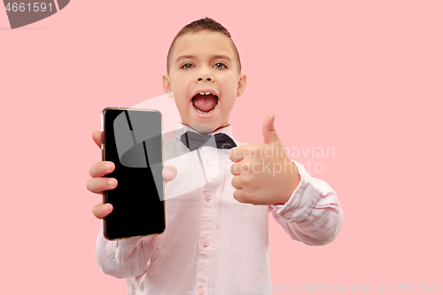 Image of Indoor portrait of attractive young boy holding blank smartphone