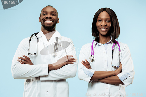 Image of The female and male f happy afro american doctors on blue background