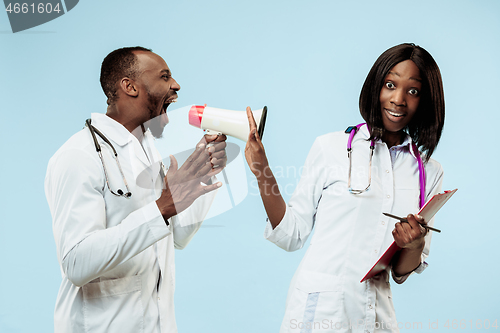 Image of The female and male happy afro american doctors on blue background