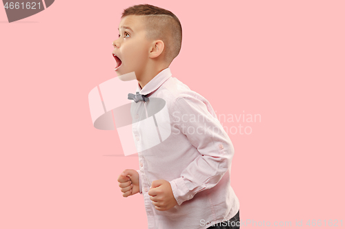 Image of Isolated on pink young casual boy shouting at studio