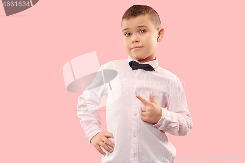 Image of The teen boy point you. portrait on pink background.