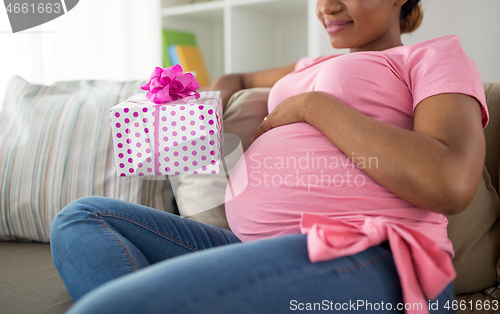 Image of african american pregnant woman with gift