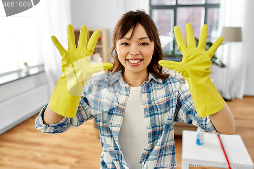 Image of asian woman with protective rubber gloves on