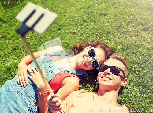 Image of happy couple taking selfie on smartphone at summer