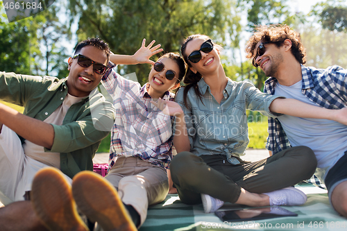 Image of happy friends taking selfie outdoors in summer