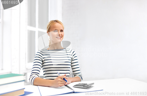 Image of student woman with books, notebook and calculator